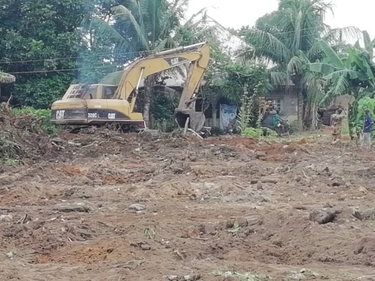 PIX 2(20): MEN AT WORK BULLDOZING THE SITE.